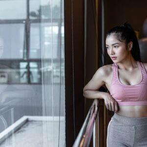 woman-standing-relaxed-hands-placed-steel-rail-gym_1150-16538